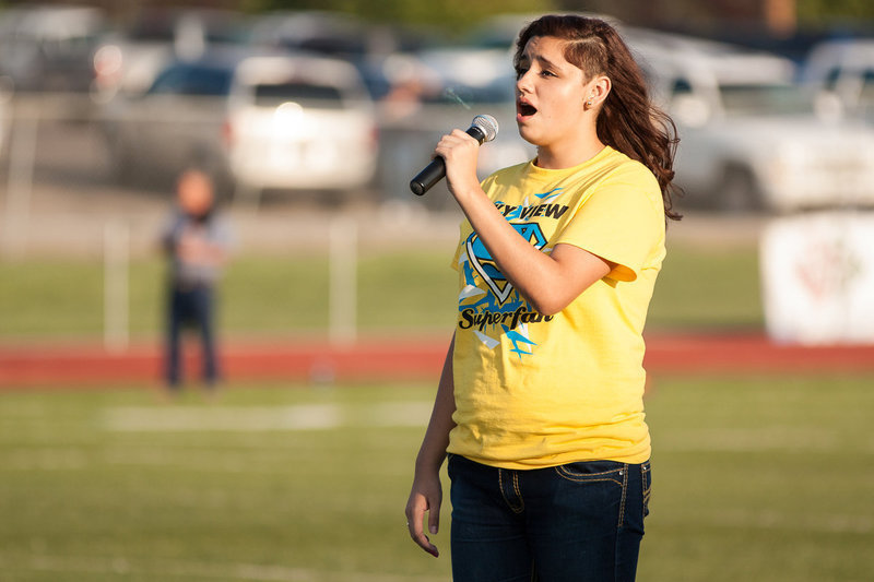 Image: Cassidy Winn sings the Star Spangled Banner.