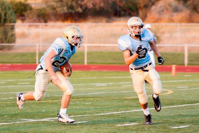 Image: Lead blocker Christian Fife (3) leads the way for one of many big runs by Skyler Hunt (24).